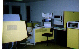 The IBM System/3 model 15D.  The CPU had 384k of memory, the disk pack in the drive on the right held 70mb of data, the unit in front of the the chair is a controller for the printer on the left.