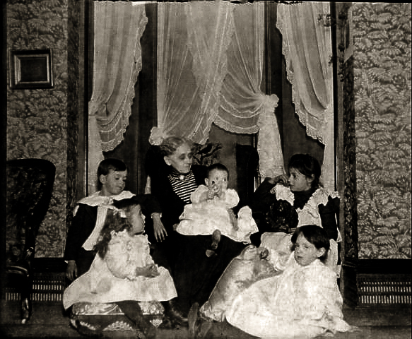 The bay window in the parlor where many marriages and funerals took place, at the base of the walls is what was to be Des Moines first ever perimeter heating - didn't work yet did provide a nice runway for the mice.  Annie Seymour Redhead with... kids.