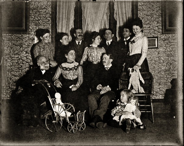Front: Uncle Henry, Helen with doll  Back George with big mustache, far right Wesley, Marjorie
